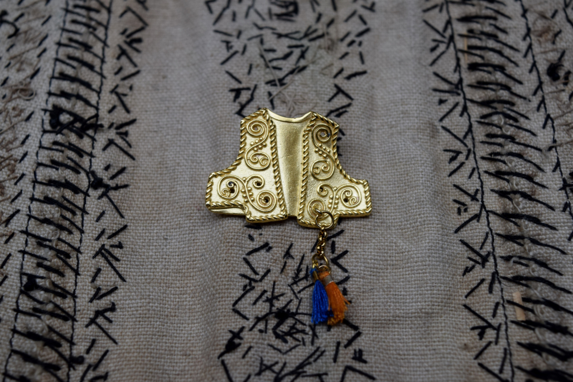 The 2024 lucky charm photographed on the reverse side of the karagouna waistcoat